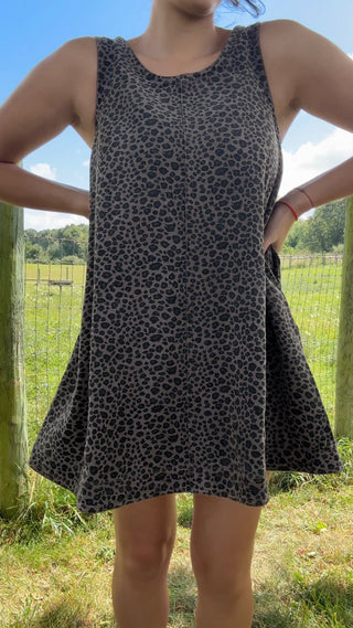 Front view of sleeveless charcoal gray swing dress with black leopard print and soft flowy A-line silhouette.