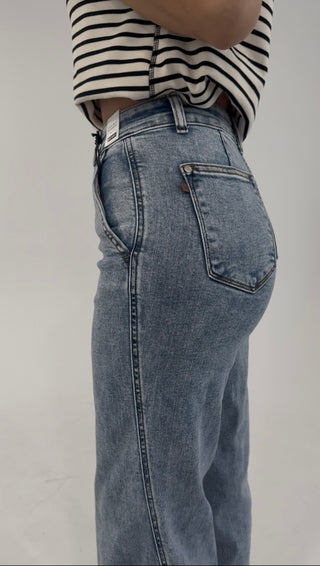 Side view of high-rise light wash denim jeans featuring a classic five-pocket design and straight-leg fit.