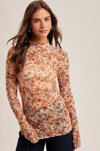 Sheer long sleeve mock neck top in autumn floral print with warm rust, gold, and burgundy tones.