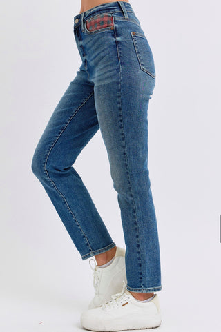 Side view of Judy Blue high-rise skinny jeans with red plaid pocket accents and classic blue denim wash.