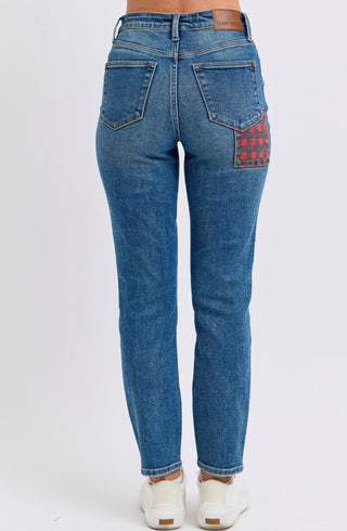 Back view of Judy Blue high-rise skinny jeans featuring a red plaid patch pocket and classic blue denim wash.