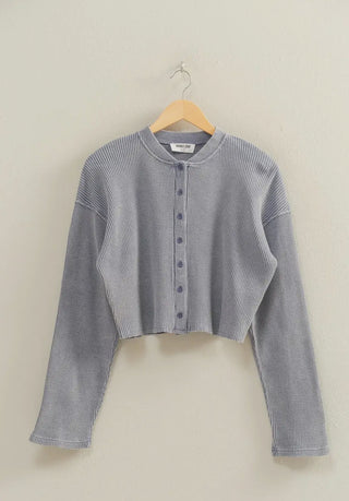 Slate blue cropped waffle-knit cardigan with long sleeves and front buttons, offering a cozy, modern boutique style.