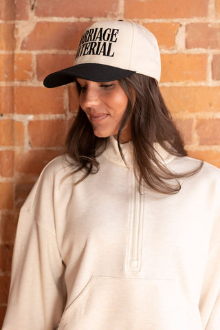 Casual chic in a cream half-zip pullover and matching high-waisted shorts, paired with white sneakers and a baseball cap