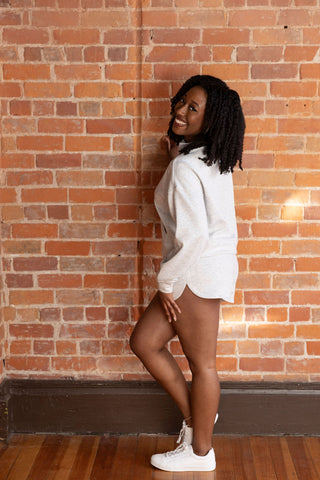 Model in a cozy gray half-zip cropped sweatshirt and matching shorts, styled effortlessly with white sneakers for a laid-back look