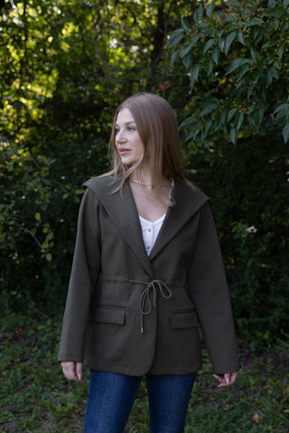 She means business drawstring jacket dark green front pockets by hem and thread