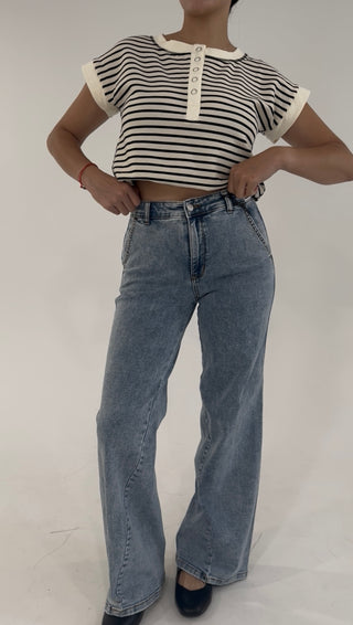 High-rise light wash wide-leg jeans styled with a cropped black and white striped henley top.