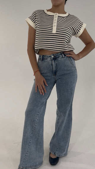 High-rise wide-leg jeans in a light vintage wash paired with a black and white striped henley crop top.