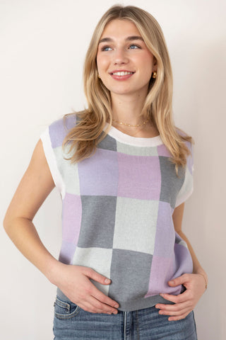 Chic pastel plaid sweater vest with soft lavender, white, and gray hues, a classic knit design, and a relaxed fit for effortless layering.