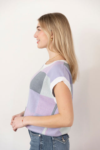 Trendy sleeveless knit vest with a pastel checkered pattern in lavender, gray, and white, perfect for casual or preppy styling.