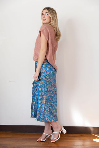 Floral blue midi skirt with a silky texture, perfect for an elegant yet casual look, styled with a cozy knit top.