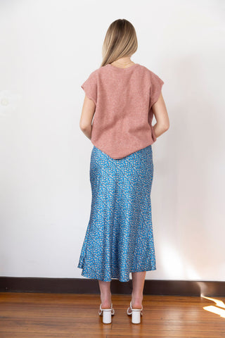 Floral blue midi skirt with a silky texture, perfect for an elegant yet casual look, styled with a cozy knit top.