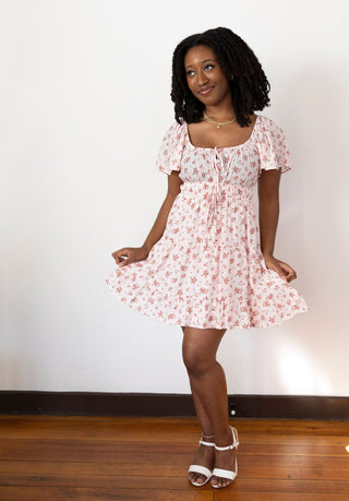 Flowy pink floral skirt with delicate ruffle hem, lightweight fabric, and a romantic vintage-inspired print for effortless charm.