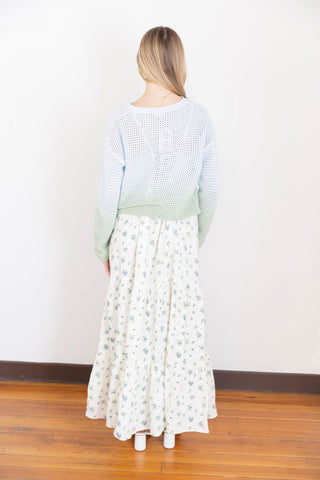 Soft ombre knit sweater in pastel blue and green with open crochet design, styled with a floral skirt for a dreamy spring outfit.